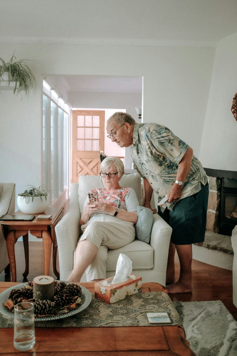 An older couple together in the front room of their own home