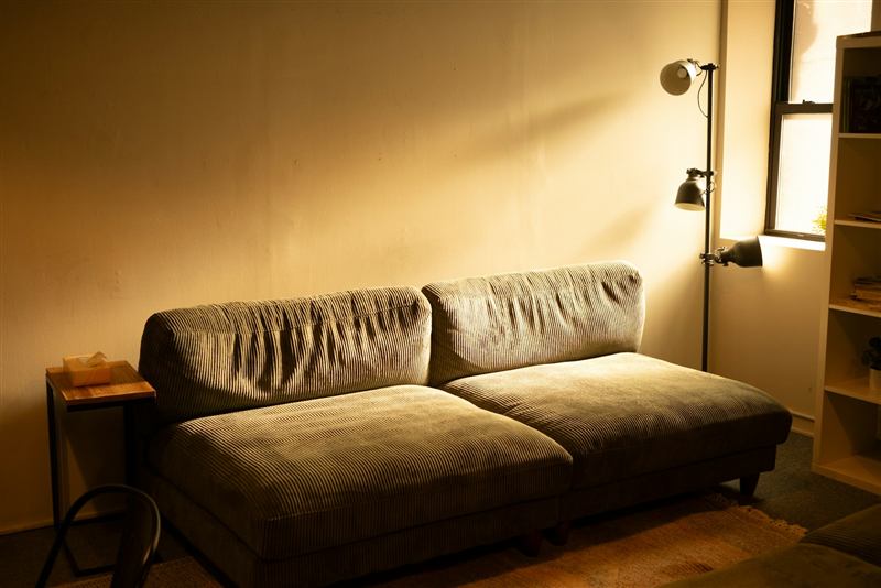 A cozy sofa in warm evening lamp light
